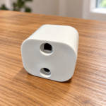Aisiting U.S. Type B grounding safety adapter on a table, front view